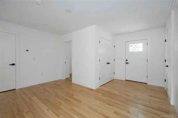 a view of entryway and hall with wooden floor