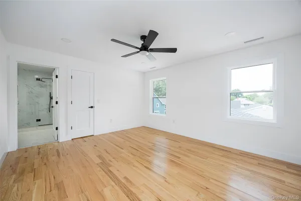 a bathroom with a shower sink mirror and toilet
