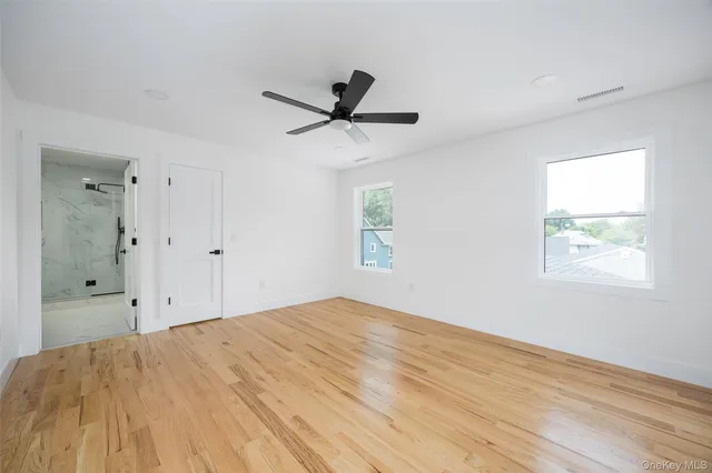 a bathroom with a shower sink mirror and toilet