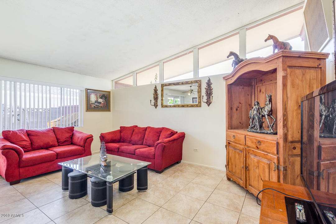 3802 West Ocotillo Road Phoenix, AZ 85019 - Photo 2 of 9 a living room with furniture a couch and large window