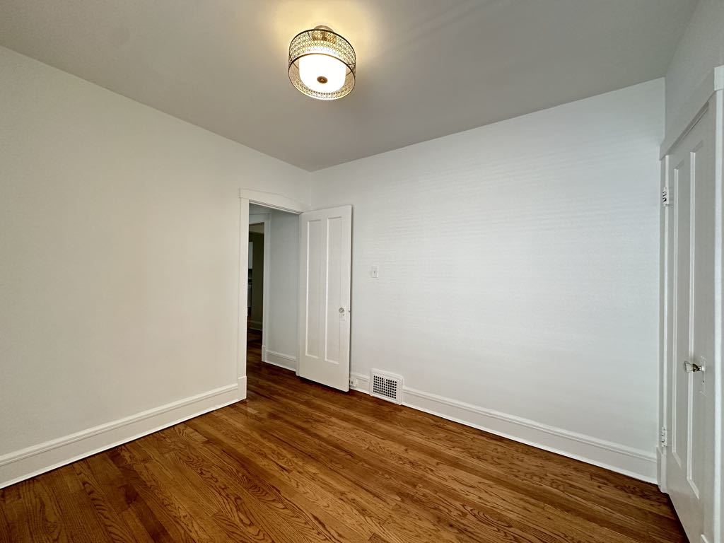 5701 North Keystone Avenue, Unit 1 Chicago, IL 60646 - Photo 14 of 20 a view of an empty room with wooden floor