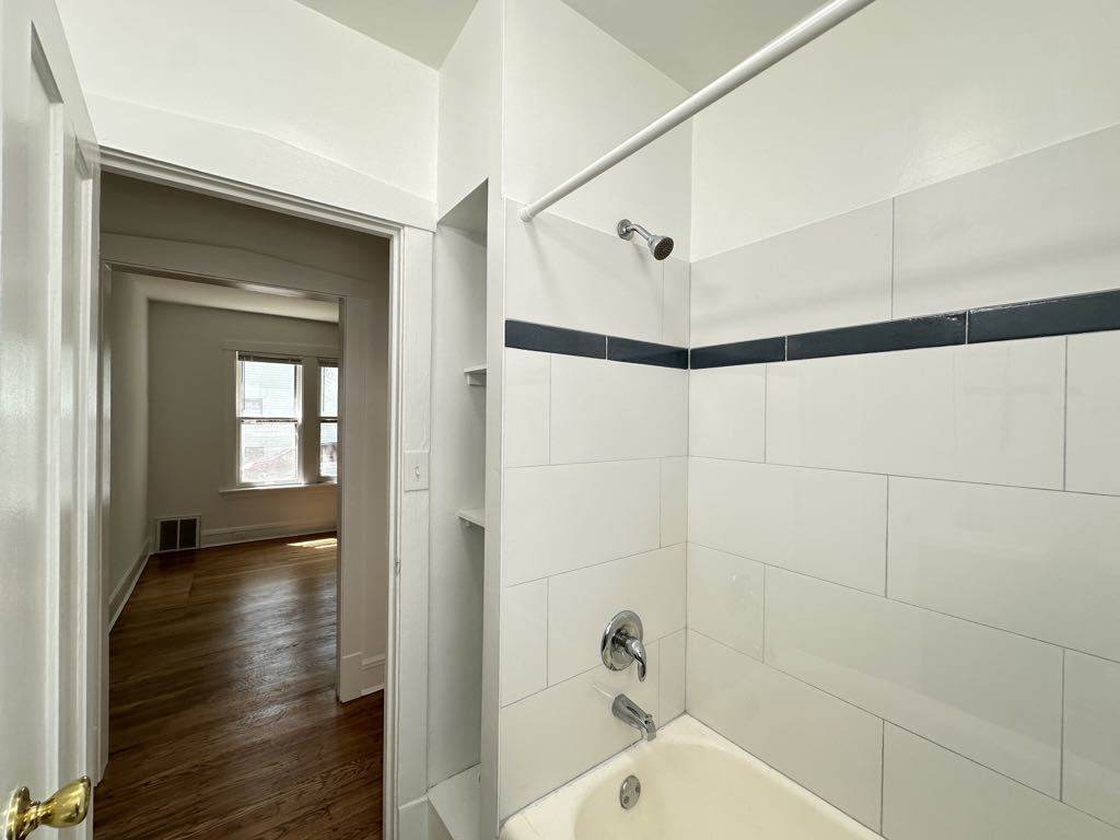 5701 North Keystone Avenue, Unit 1 Chicago, IL 60646 - Photo 20 of 20 a bathroom with a bathtub and shower