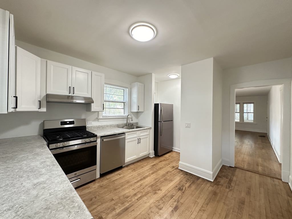 5701 North Keystone Avenue, Unit 1 Chicago, IL 60646 - Photo 4 of 20 a kitchen with stainless steel appliances granite countertop a stove and a refrigerator