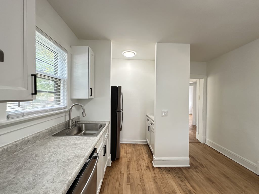 5701 North Keystone Avenue, Unit 1 Chicago, IL 60646 - Photo 5 of 20 a kitchen with a refrigerator and a sink