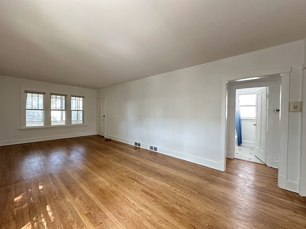 5701 North Keystone Avenue, Unit 1 Chicago, IL 60646 - Photo 9 of 20 a view of empty room with wooden floor and fan