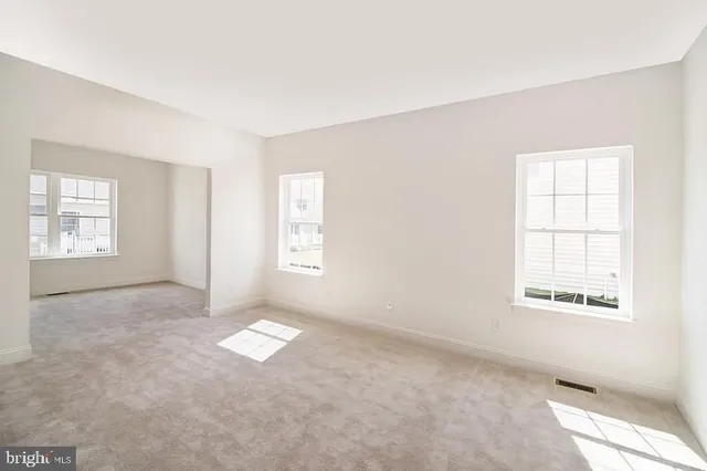 an empty room with windows and closet