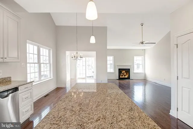 a open kitchen with cabinets a counter top space stainless steel appliances and a window