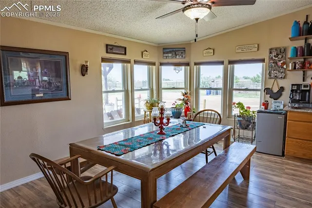 a kitchen with granite countertop lots of clutter and stainless steel appliances