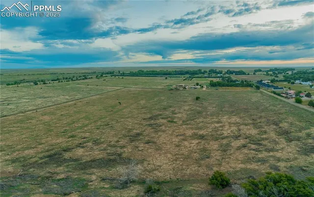 a view of a field with an ocean
