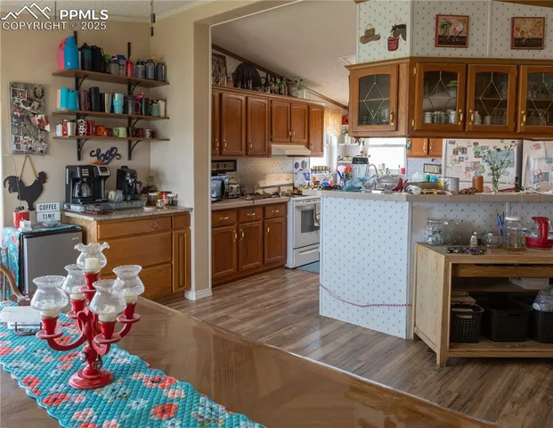 a kitchen with stainless steel appliances granite countertop a stove and cabinets