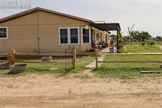 a view of a backyard with wooden fence