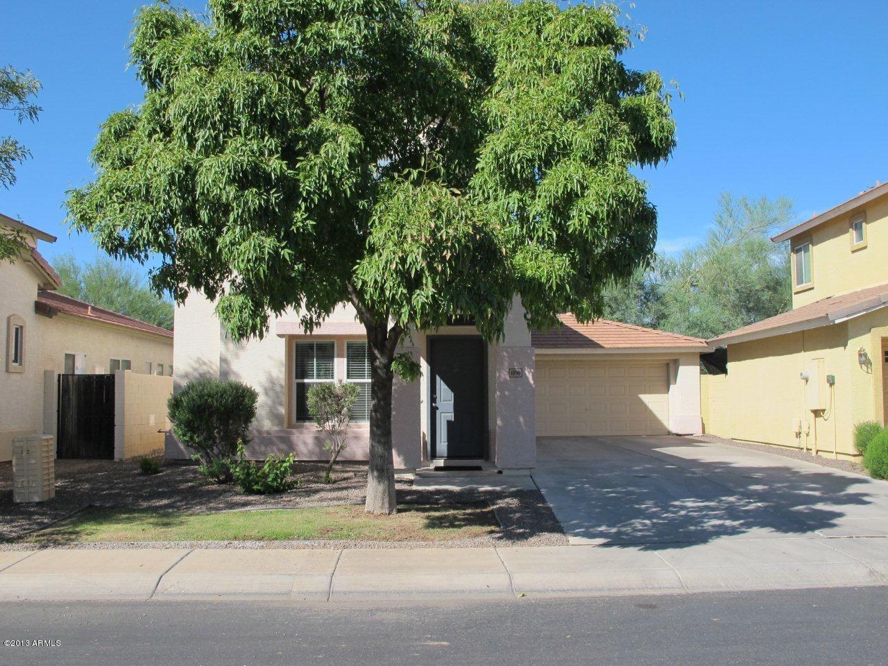 1890 South Rome Street Gilbert, AZ 85295 - Photo 1 of 18 a front view of a house with a yard and garage