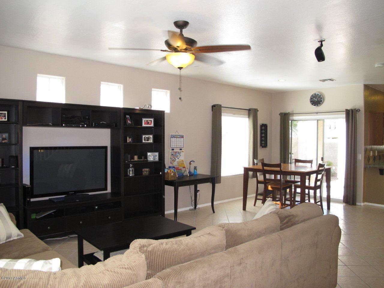 1890 South Rome Street Gilbert, AZ 85295 - Photo 3 of 18 a living room with furniture a flat screen tv and a fireplace