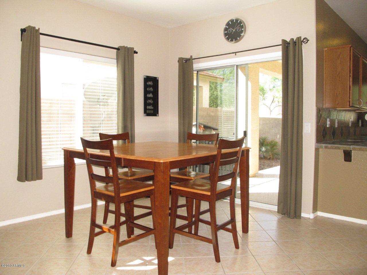 1890 South Rome Street Gilbert, AZ 85295 - Photo 8 of 18 a view of a dining room with furniture and a window