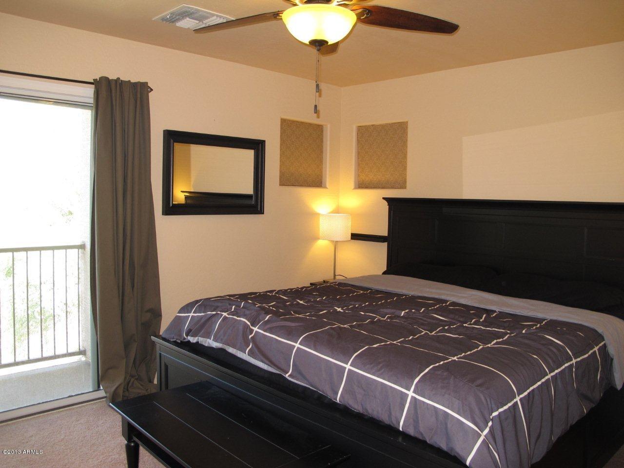 1890 South Rome Street Gilbert, AZ 85295 - Photo 9 of 18 a bedroom with a bed and a lamp