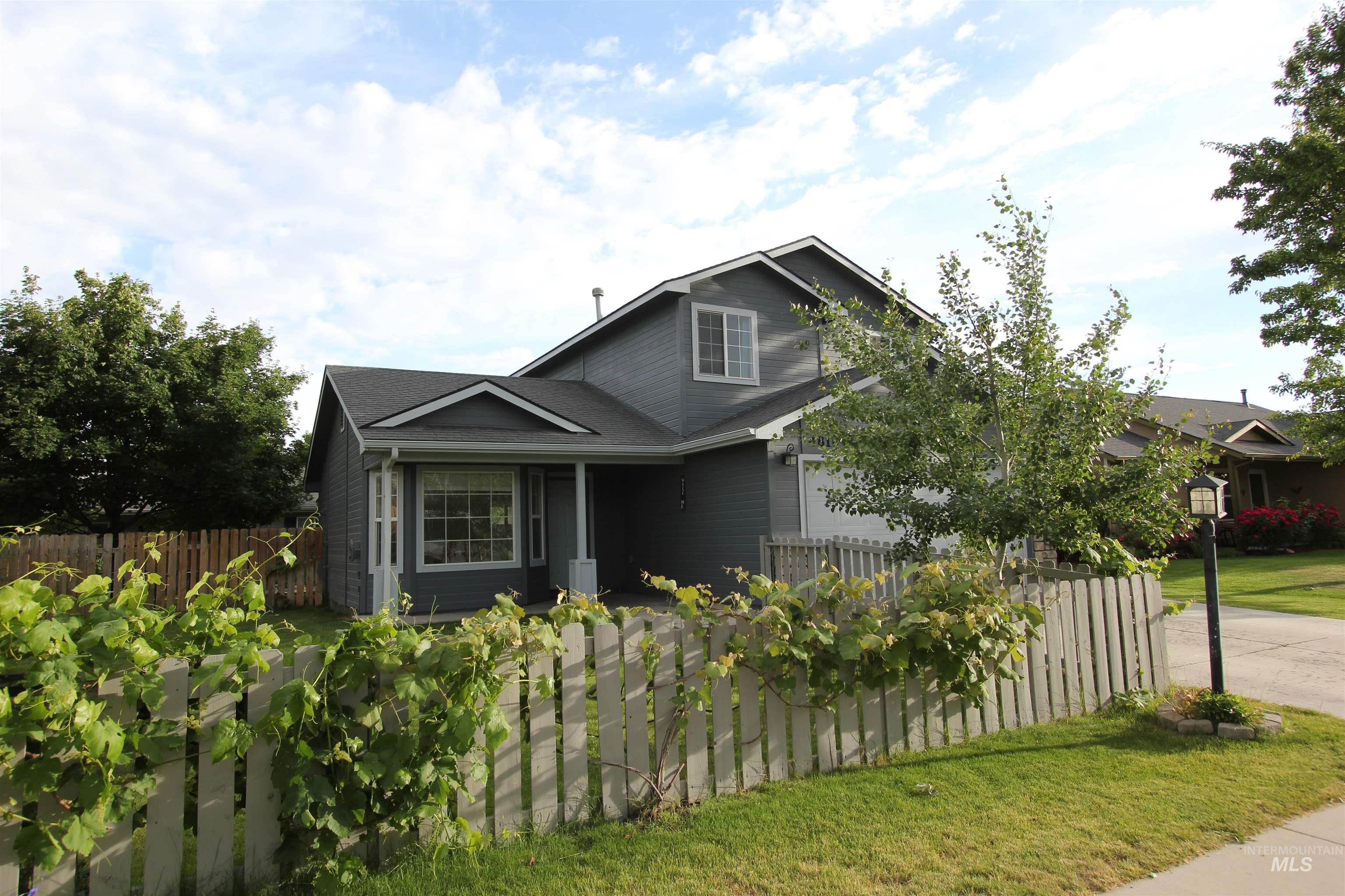 4816 Kadie Street Caldwell, ID 83607 - Photo 4 of 23 Two-story residence featuring grey siding, white trim, and an attached garage