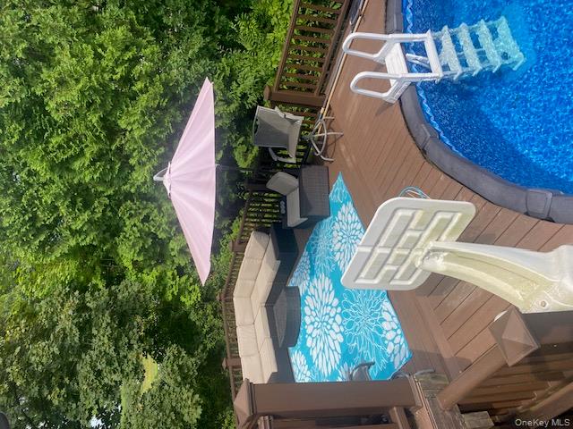 52 Woodland Road Highland Mills, NY 10930 - Photo 16 of 47 View of swimming pool with an outdoor living space, a wooden deck, and a hot tub