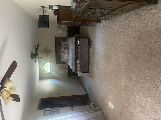 52 Woodland Road Highland Mills, NY 10930 - Photo 20 of 47 Bedroom with light carpet, a ceiling fan, electric panel, and a baseboard heating unit