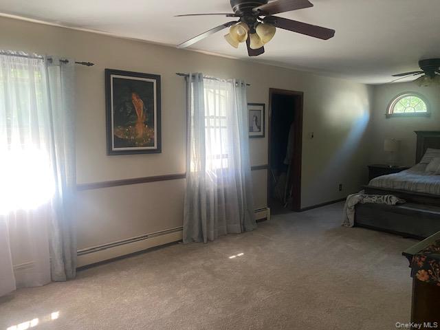 52 Woodland Road Highland Mills, NY 10930 - Photo 25 of 47 Bedroom featuring carpet flooring, baseboard heating, and a ceiling fan