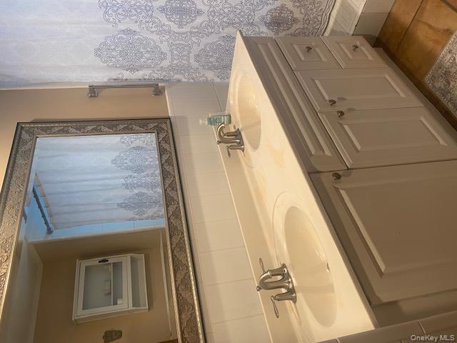 52 Woodland Road Highland Mills, NY 10930 - Photo 27 of 47 Full bathroom featuring double vanity, tile patterned flooring, curtained shower, and a wainscoted wall