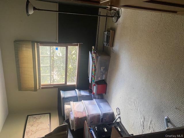 52 Woodland Road Highland Mills, NY 10930 - Photo 32 of 47 Carpeted bedroom with wainscoting and a baseboard heating unit