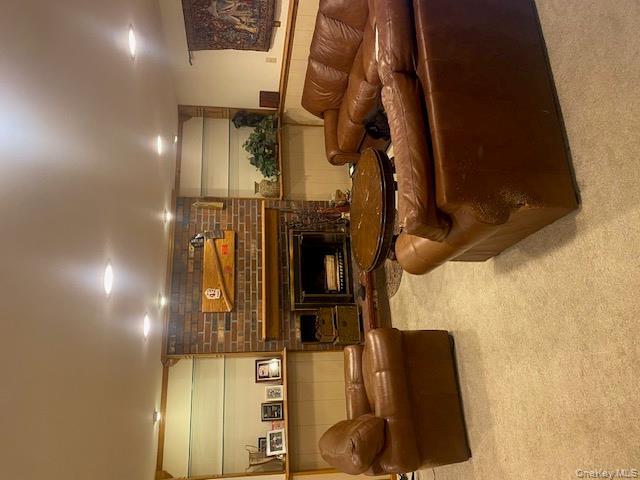 52 Woodland Road Highland Mills, NY 10930 - Photo 33 of 47 Living room with light colored carpet and a fireplace