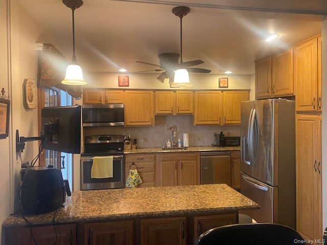 52 Woodland Road Highland Mills, NY 10930 - Photo 6 of 47 Kitchen featuring appliances with stainless steel finishes, a peninsula, light stone counters, hanging light fixtures, and recessed lighting