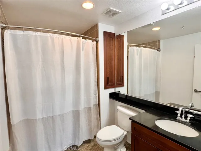 a dining room with furniture potted plants and wooden floor