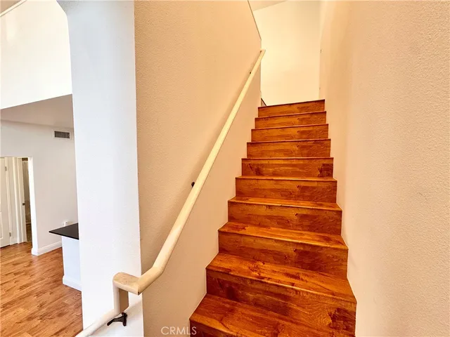 a living room with furniture a flat screen tv and a floor to ceiling window