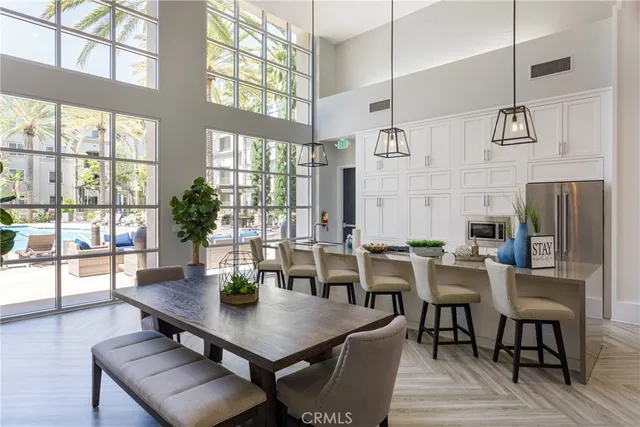 a view of a patio with couches table and chairs with plants and trees
