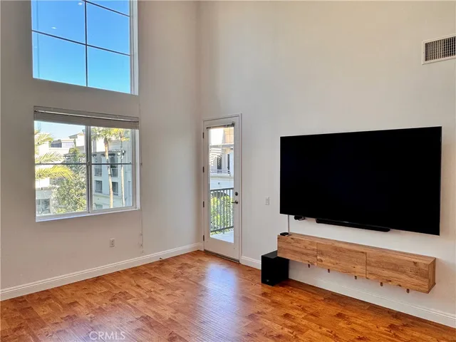 a view of a multi story residential apartment building with a yard