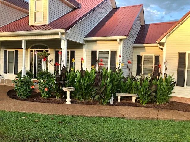 a living room with furniture wooden floor and a large window