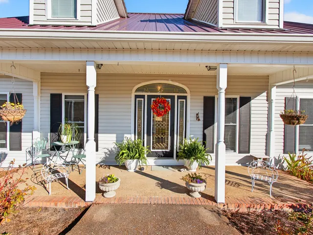 a kitchen with stainless steel appliances granite countertop a refrigerator a stove and a sink with wooden floor