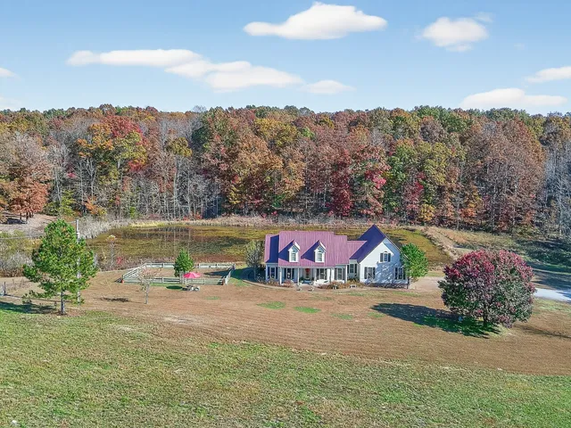 a view of a house with a yard and a garage