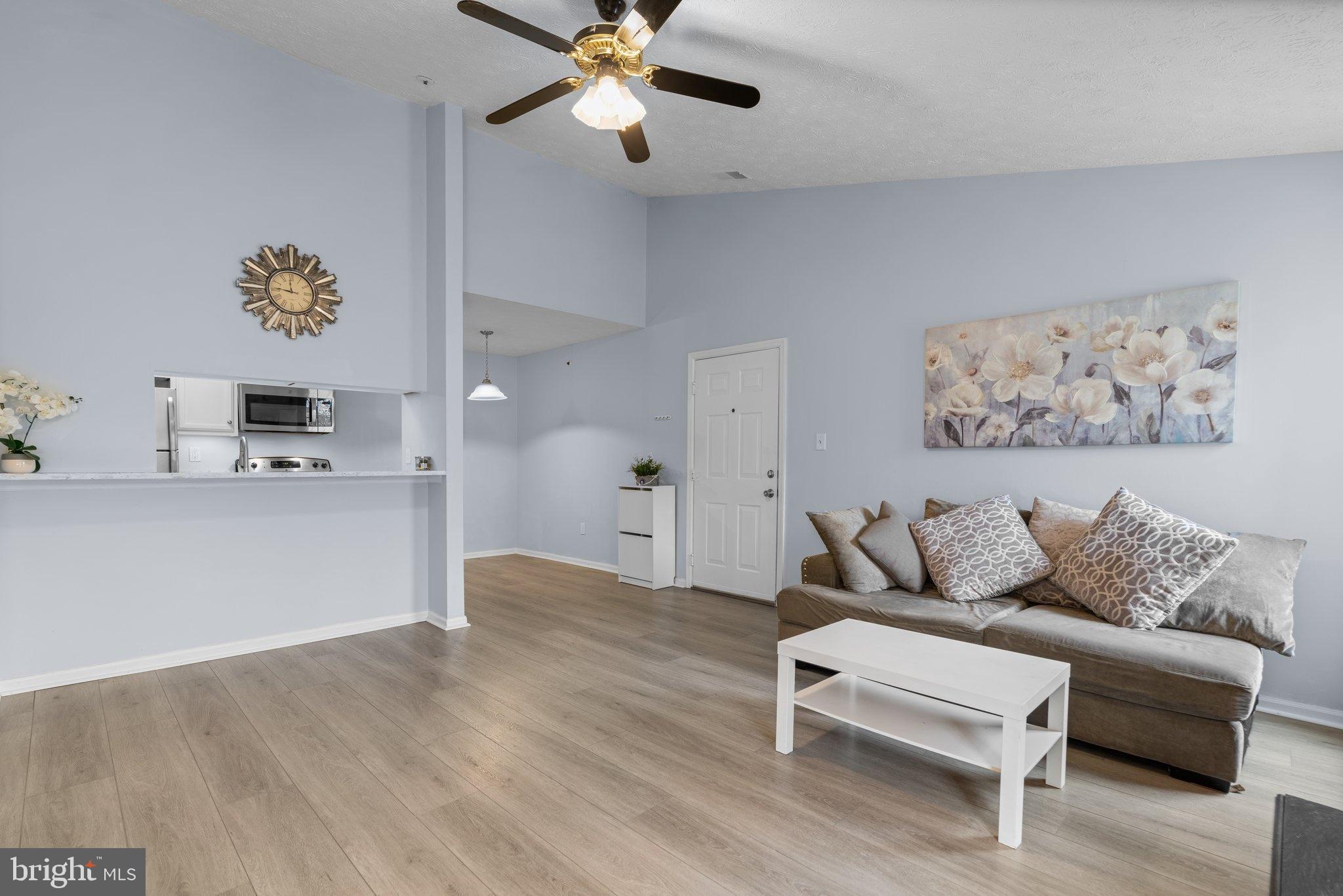 6410 Greenfield Road, Unit 1008 Elkridge, MD 21075 - Photo 3 of 13 a living room with furniture and a wooden floor