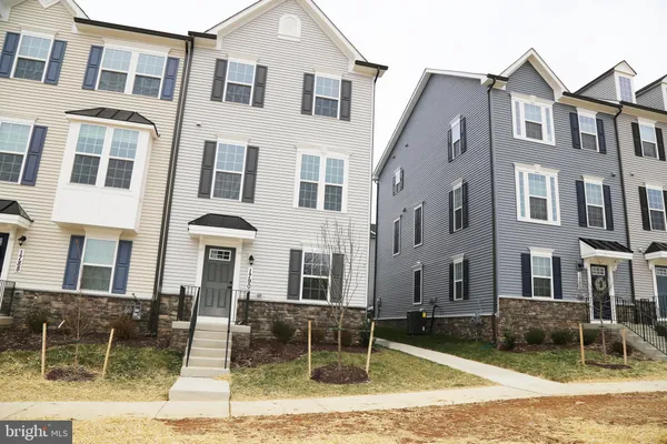 a front view of a residential apartment building with a yard