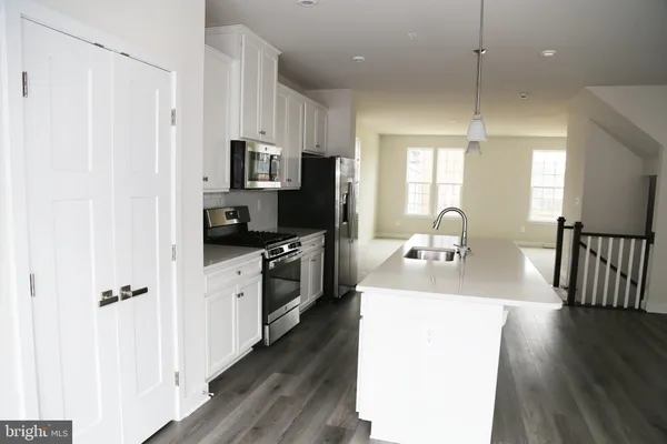 a kitchen with a sink appliances and cabinets