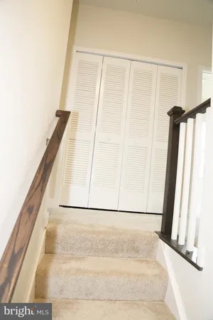 a view of staircase with white walls