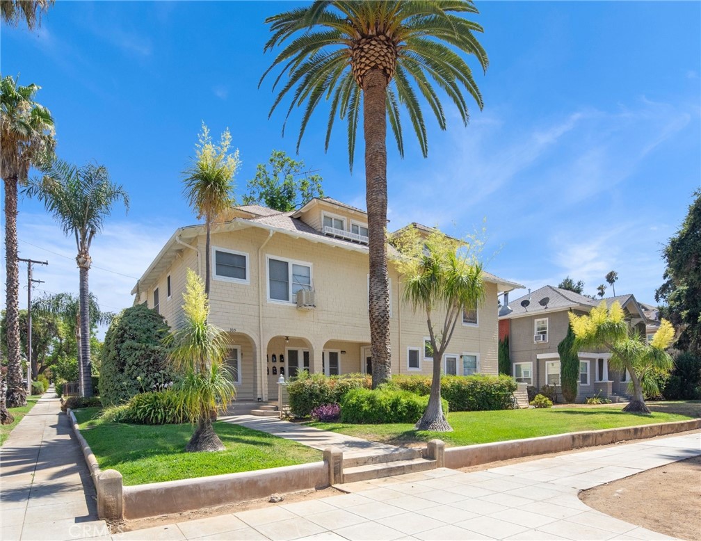 305 West Olive Avenue Redlands, CA 92373 - Photo 2 of 16 a front view of a house with a yard and palm trees