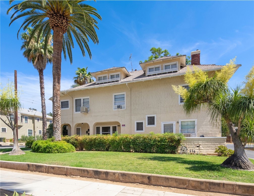 305 West Olive Avenue Redlands, CA 92373 - Photo 3 of 16 a front view of a house with a garden and a yard