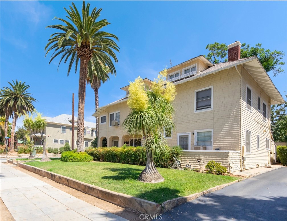 305 West Olive Avenue Redlands, CA 92373 - Photo 5 of 16 a front view of a house with a yard and potted plants