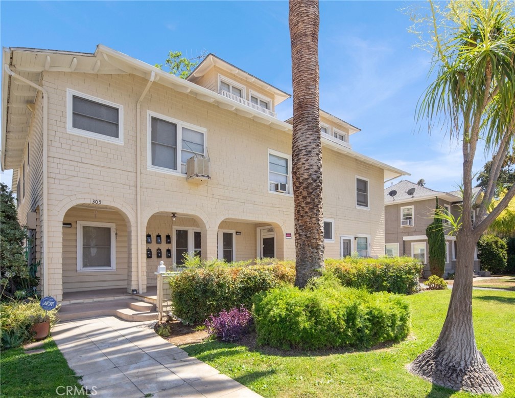 305 West Olive Avenue Redlands, CA 92373 - Photo 6 of 16 a front view of a house with yard and green space