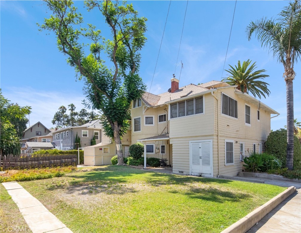 305 West Olive Avenue Redlands, CA 92373 - Photo 9 of 16 a view of a white house with a swimming pool