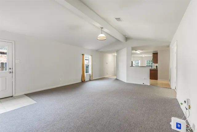 an empty room with windows and cabinet