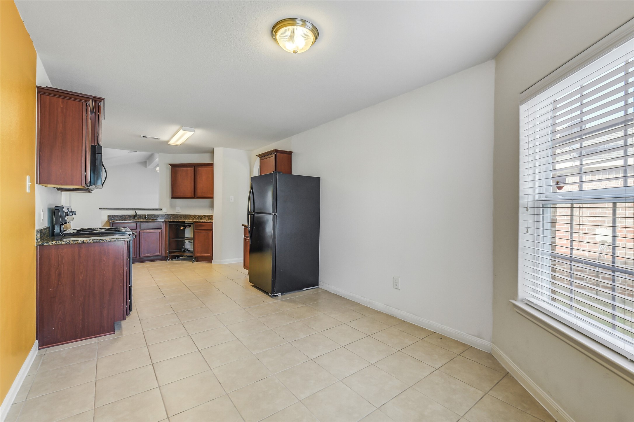 22719 Tabberts Way Hockley, TX 77447 - Photo 10 of 28 a kitchen with stainless steel appliances granite countertop a refrigerator sink and stove