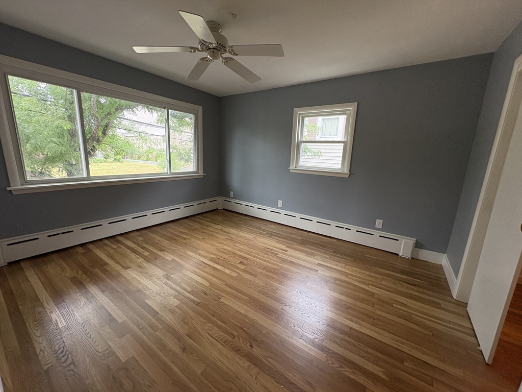 764 Hancock Street, Unit 2 Quincy, MA 02170 - Photo 6 of 6 a view of a room with wooden floor and a window