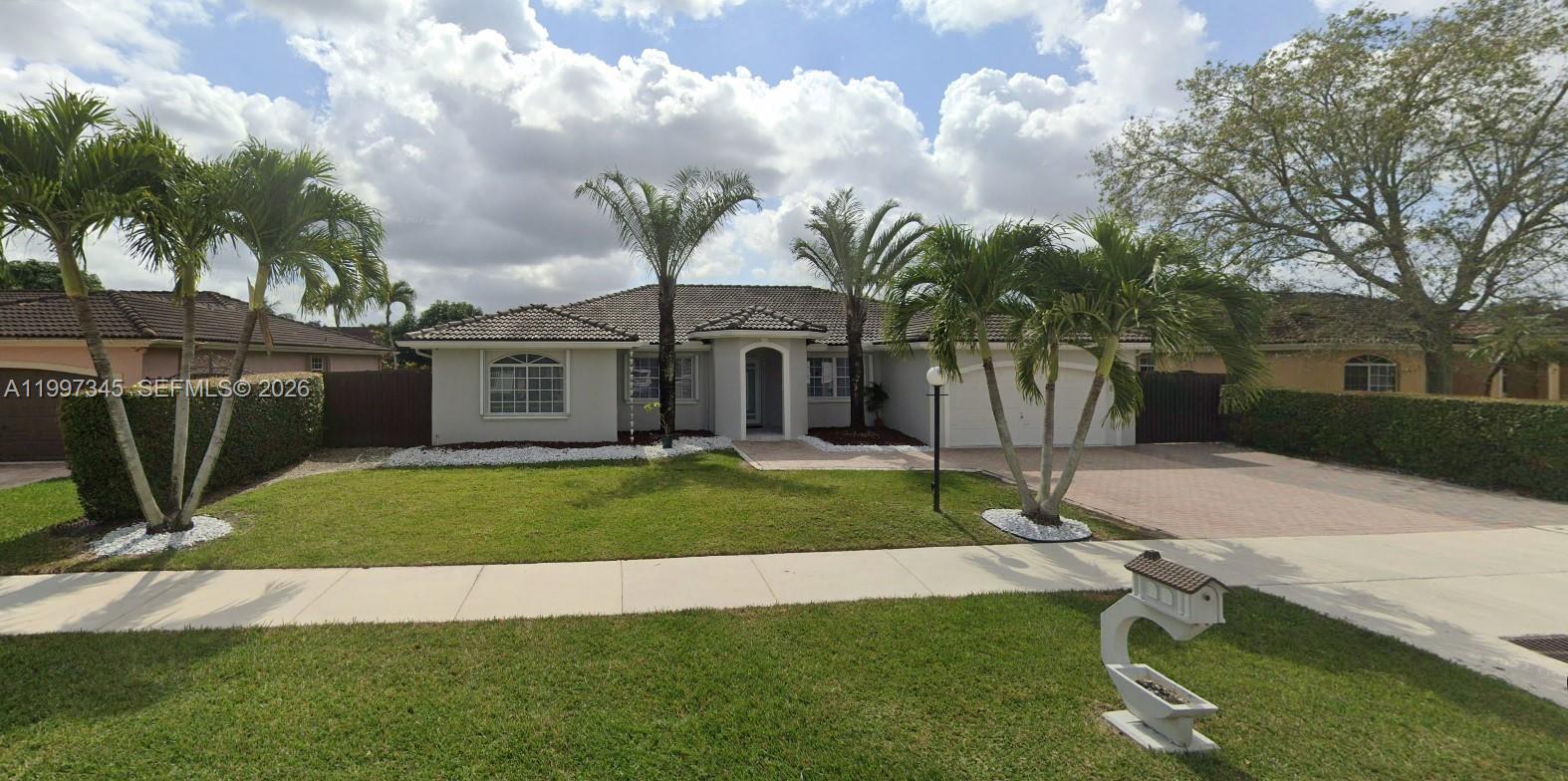 a front view of a house with garden