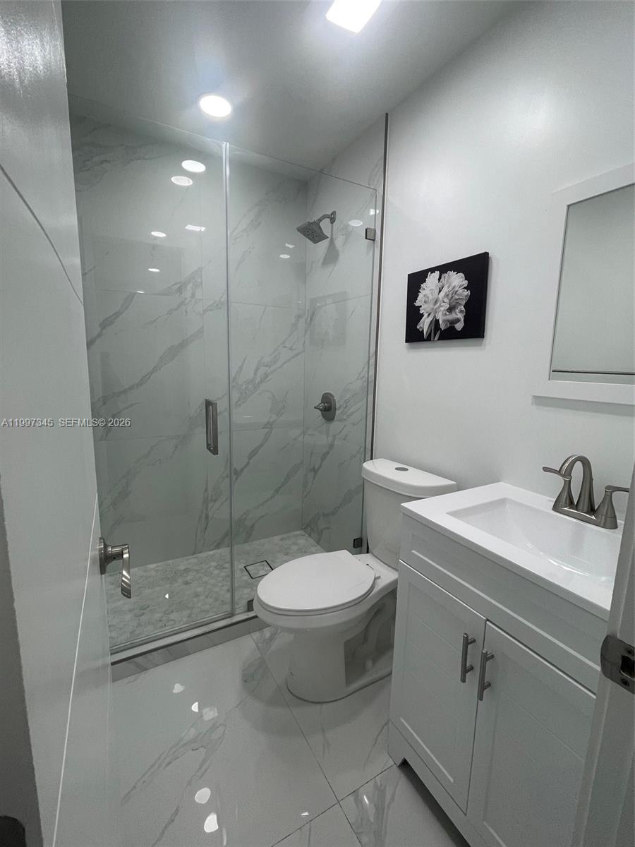 15426 Southwest 168th Terrace, Unit 2 Miami, FL 33187 - Photo 3 of 12 a bathroom with a sink toilet and shower