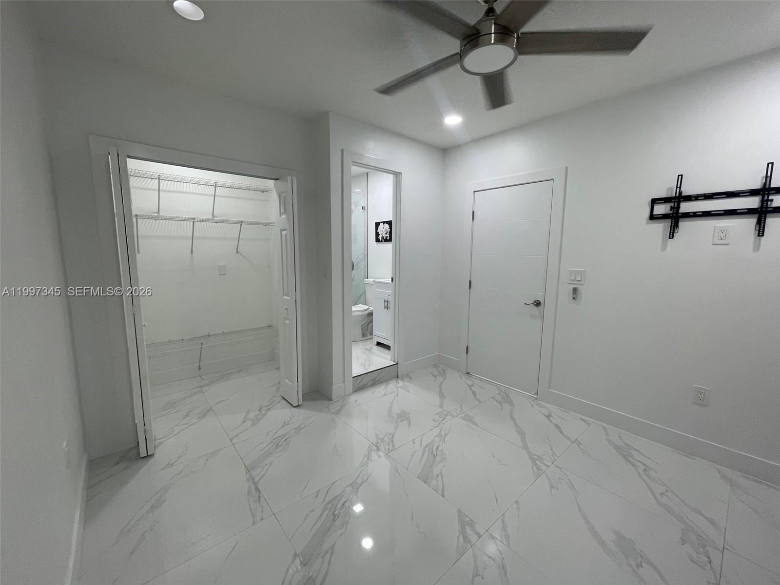 15426 Southwest 168th Terrace, Unit 2 Miami, FL 33187 - Photo 7 of 12 wooden floor in an empty room