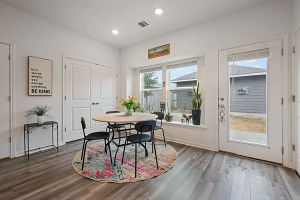 a view of a dining room with furniture and wooden floor